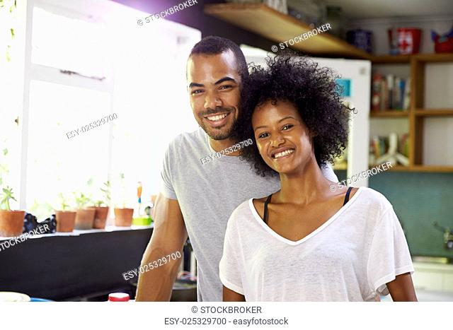 Young Couple Preparing Breakfast In Kitchen Together