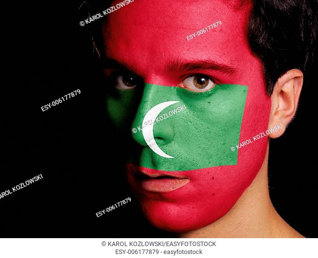 Flag of Maldives Painted on a Face of a Young Man