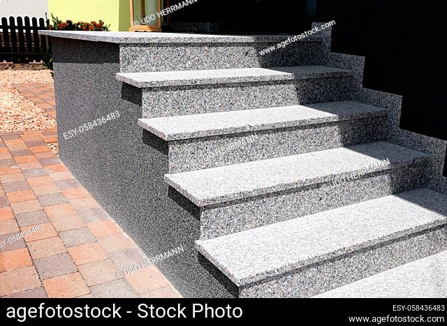Block staircase with base from colored stone plaster as entrance stairs at a house