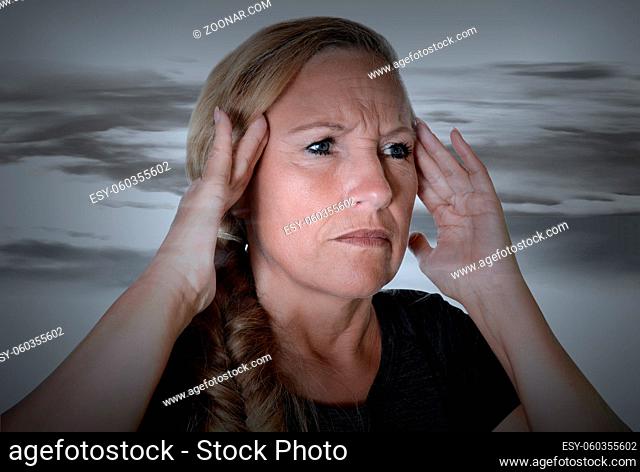 Senior having a headache and holding her head