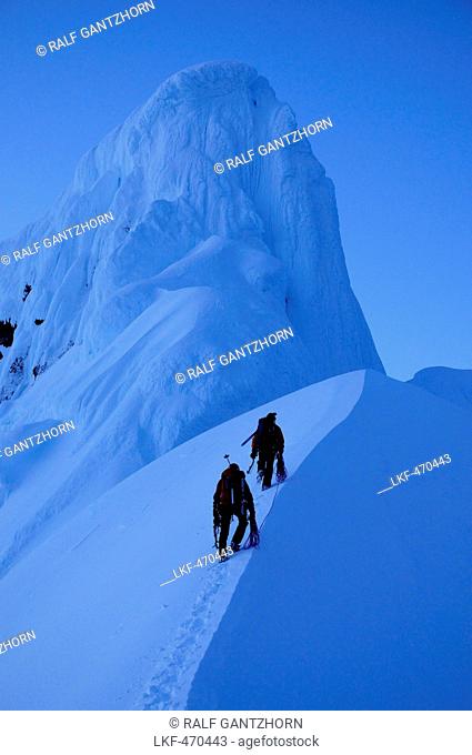 Two mountaineers ascending to west summit of Monte Sarmiento, Cordillera Darwin, Tierra del Fuego, Chile