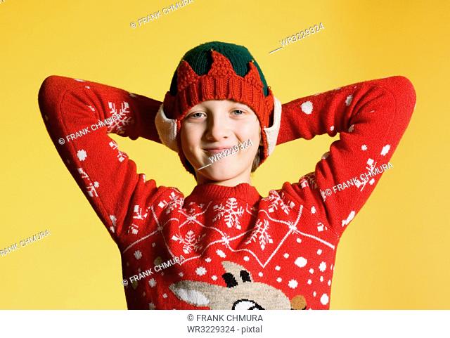 Portrait of a Boy with Blond Hair in Red Christmas Sweater