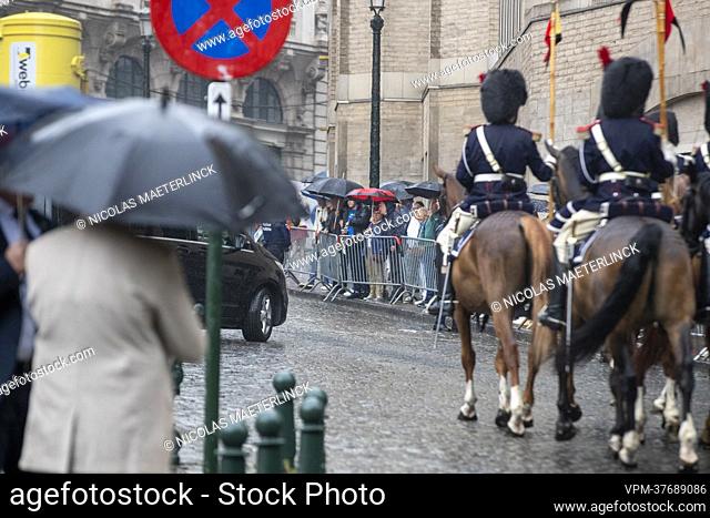 Illustration picture shows people with umbrella's waiting outside during the Te Deum mass, on the occasion of the Belgian National Day