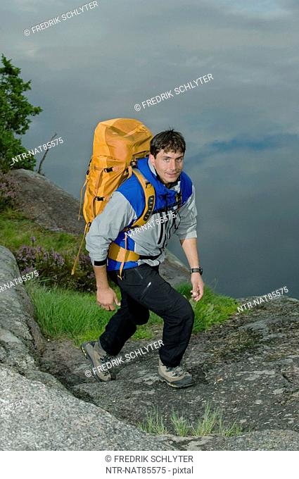 Portrait of a man hiking by a lake, Sweden