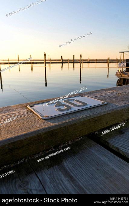 Free mooring in the sunset on a jetty in the marina of Marina Wendtorf, Schleswig-Holstein, Germany