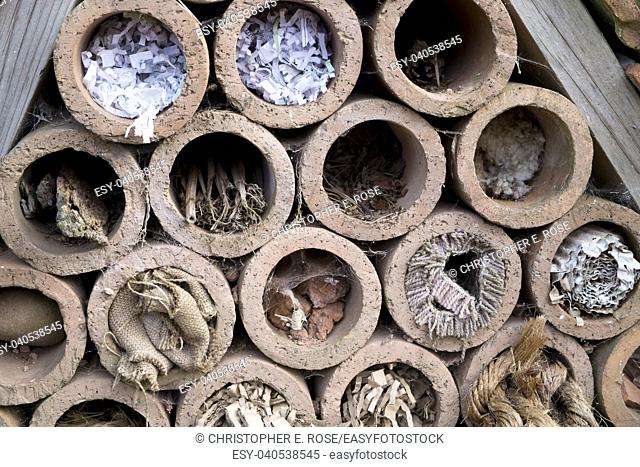 Insect hotel offering nest places in clay pipes