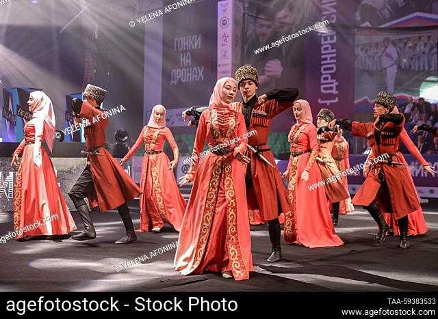 RUSSIA, GROZNY - MAY 25, 2023: Performers in traditional Chechen costume dance at the 1st international competitive programming festival, Kod Mira [World Code]