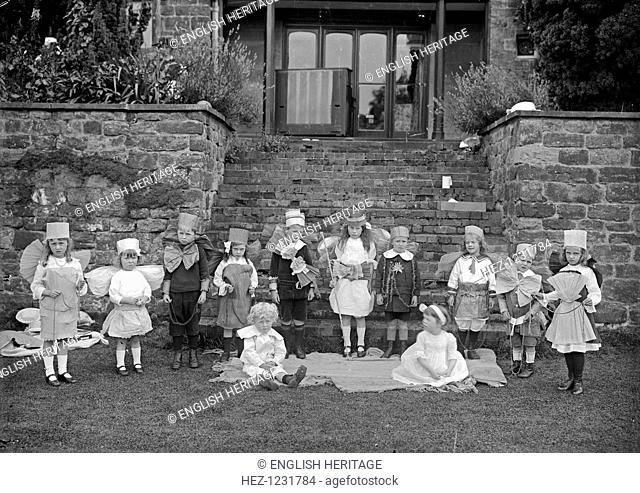 A children's party, Hellidon House, Northamptonshire, 1904. A group of children in costume posed around the steps outside the porch at Hellidon House