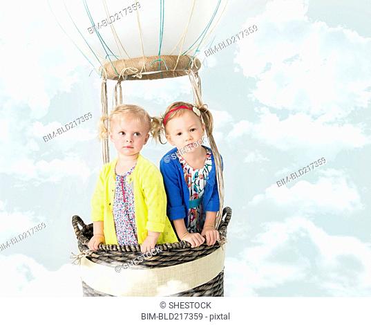 Girls playing in pretend hot air balloon