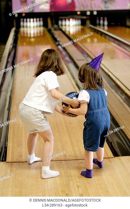 Toddlers make an attempt to bowl at birthday party