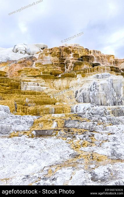 The calcium and mineral deposits under a cloiudy sky at Mammoth hot springs in Yellowstone National Park