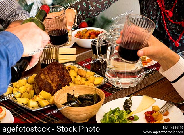 close up of food and hands taking wine - familiar dinner together or lunch - celebrating something