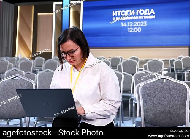 RUSSIA, MOSCOW - DECEMBER 14, 2023: A journalist using a laptop computer is seen before the start of an annual national live televised question-and-answer...