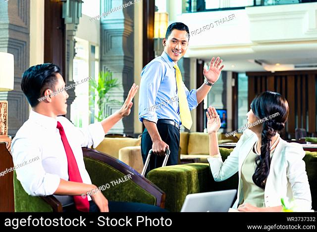 Asian Businesspeople saying goodbye in a hotel