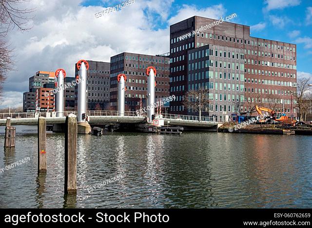 Dutch canal in city Utrecht with modern drawbridge and office buildings