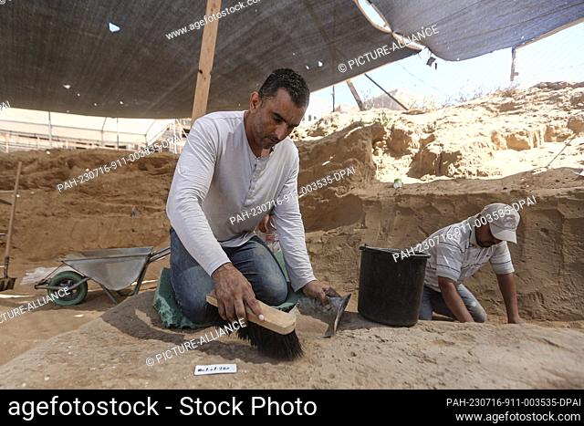 16 July 2023, Palestinian Territories, Beit Lahia: A Palestinian excavation team working at a Roman-era cemetery in the northern Gaza Strip