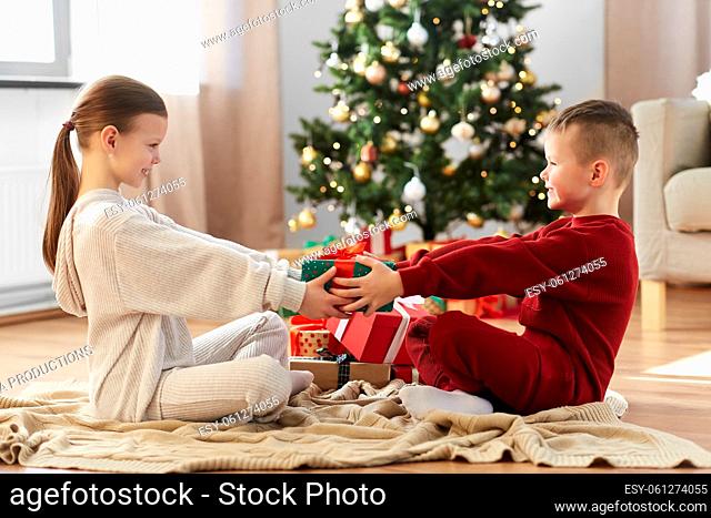 happy children with christmas gift at home