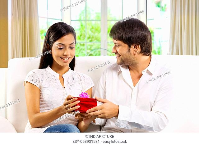 Man giving a gift to his wife
