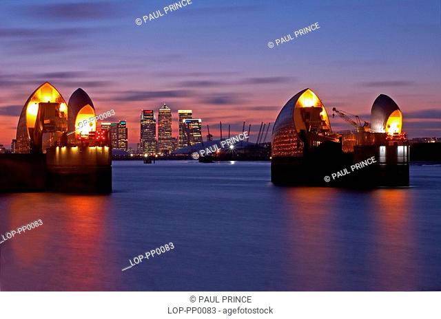 England, London, Woolwich, Thames Barrier at dusk. Built in 1984 as London's flood defence, the 1716 feet width of the river is divided by nine reinforced...