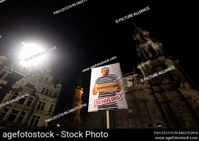 18 December 2023, Saxony, Dresden: A poster showing Michael Kretschmer (CDU), Minister President of Saxony, as a prisoner with the word ""guilty"" is carried at...
