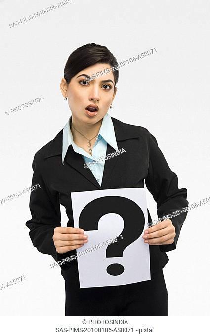 Businesswoman holding a card with question mark