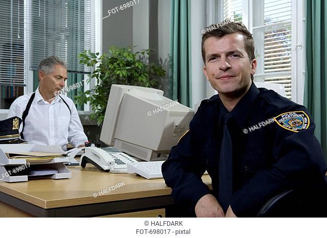 Two police officers working in an office