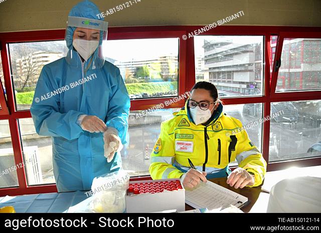 Medical workers arranges vials containing swab samples in the high school , Prato, ITALY-15-01-2021