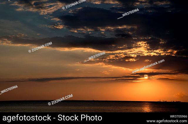 Beautiful sunset with dramatic clouds in the sky over the ocean in the island of Cyprus