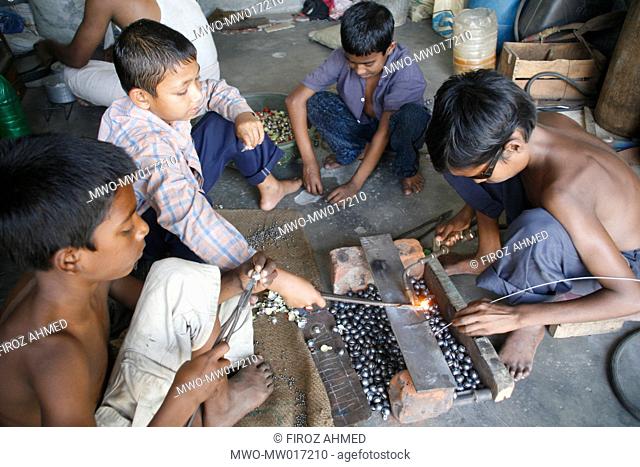 Children work at a welding shop in Shampur, Dhaka, Bangladesh march 25, 2008