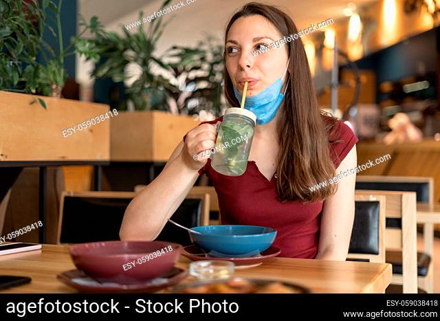 New normal concept of woman with mask eating in restaurant . High quality photo