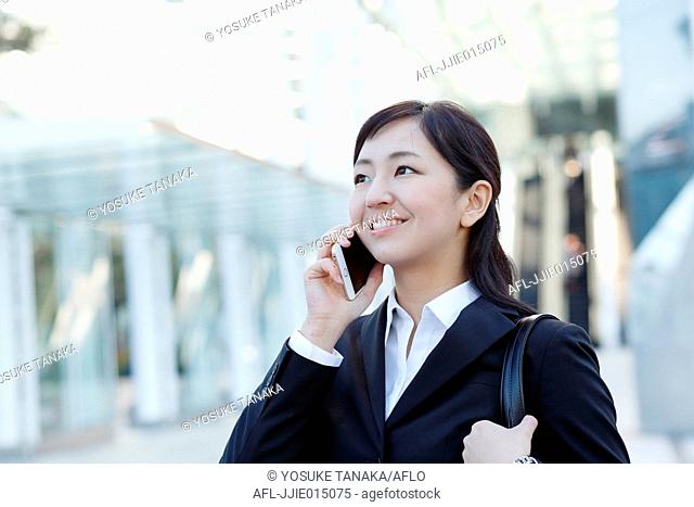 Japanese young businesswoman on the phone downtown Tokyo