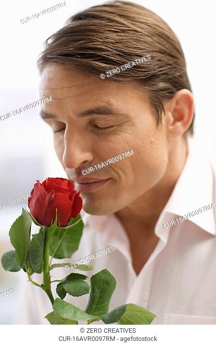 handsome man and the scent of a rose