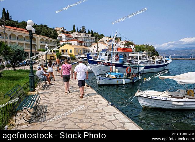 Kassiopi, Corfu, Greece, fishing boats and an excursion boat in the harbor of Kassiopi, a small port town in the northeast of the Greek island of Corfu