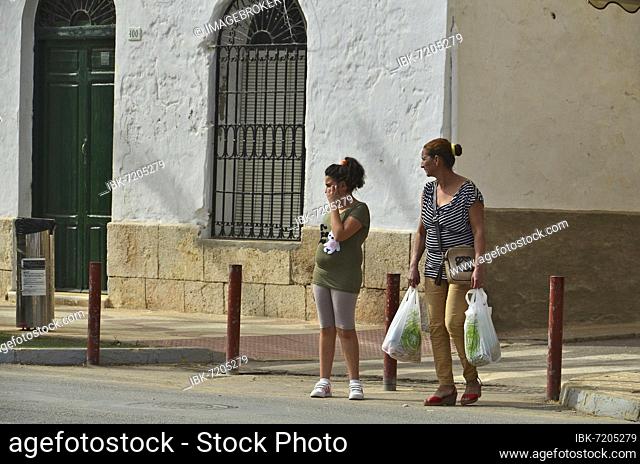 Mother with daughter coming from shopping with plastic bags, Villaricos, Andalucia, Spain, Europe