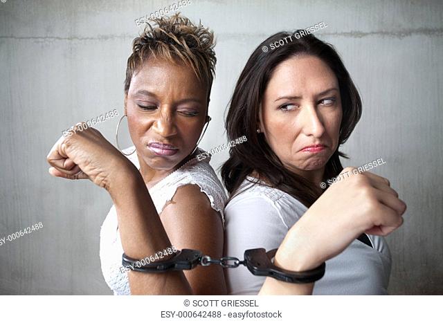 Angry women in handcuffs