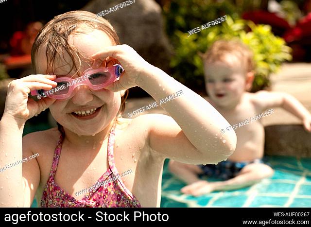 Portrait of happy girl with pink wimming goggles, Koh Samui, Thailand