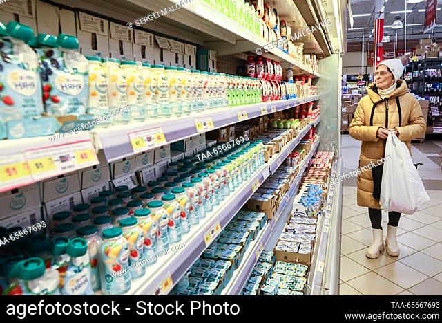 RUSSIA, SIMFEROPOL - DECEMBER 12, 2023: A woman shops for dairy products in the 7M Beztsen superstore during the Christmas season