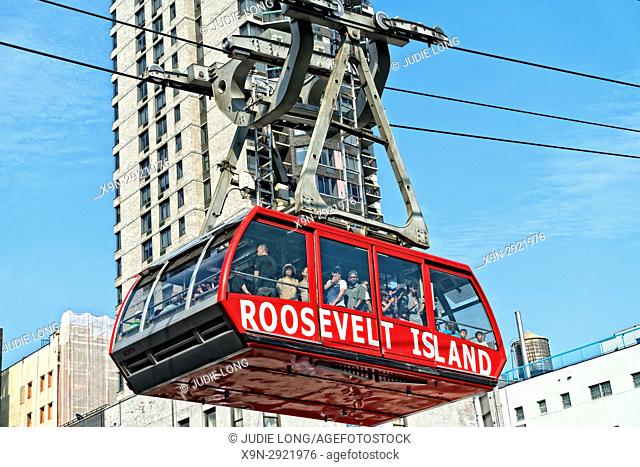 New York City, Manhattan. Looking up at the Roosevelt Island Tramway approaching the station in Manhattan