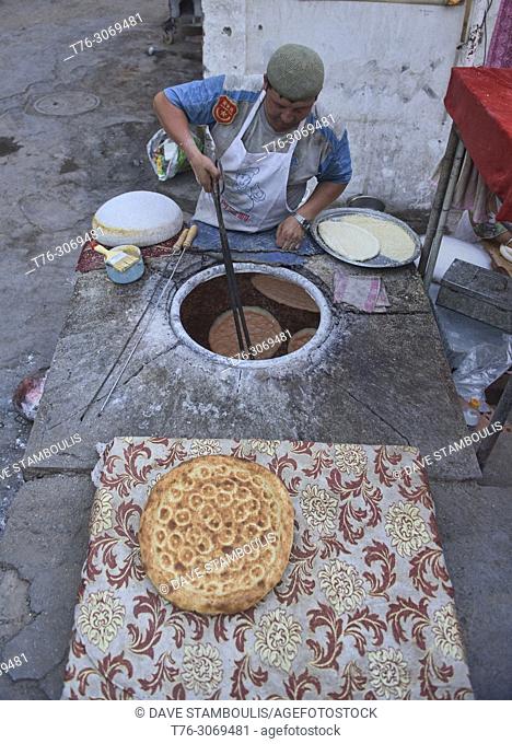 Fresh tandoori-baked nang, Uyghur flatbread, Turpan, Xinjiang, China
