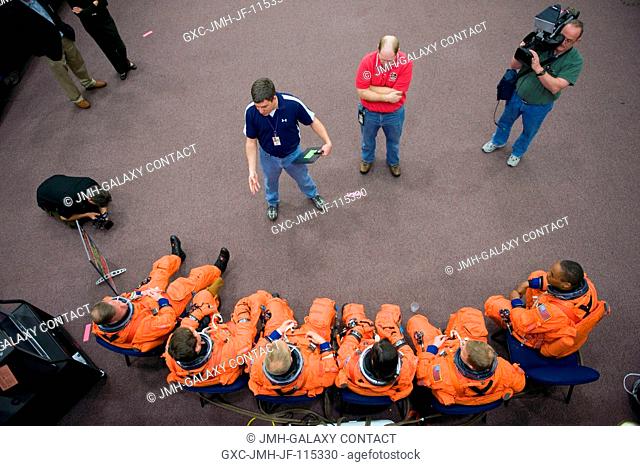 Crew instructors brief the STS-133 crew members prior to the start of a training session in the crew compartment trainer (CCT-2) in the Space Vehicle Mockup...
