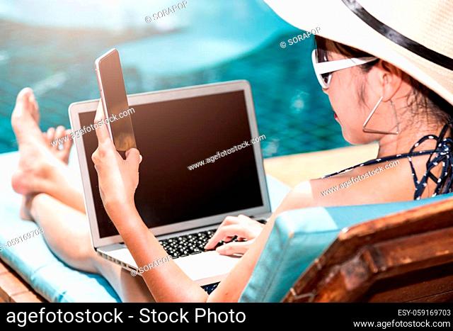 Portrait Beautiful girl woman enjoying relaxing with mobile phone near swimming pool blue water