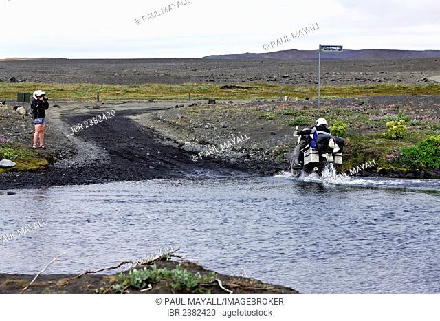 Motor bike attempting water crossing on the F88 highlands road, Iceland, Europe