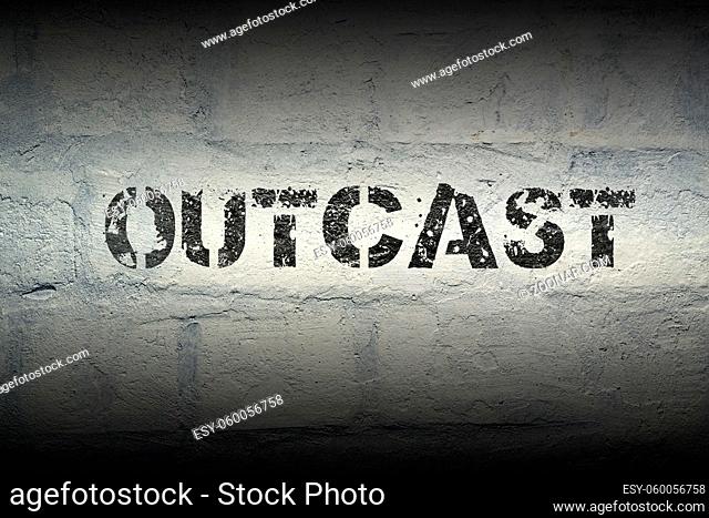 outcast word stencil print on the grunge white brick wall
