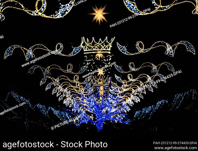 12 December 2023, Saxony, Dresden: The ""Augustusmarkt"" Christmas market on the main street is illuminated for Christmas. Photo: Robert Michael/dpa
