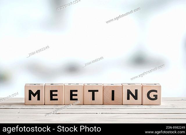 Meeting sign with wooden blocks on an office desk