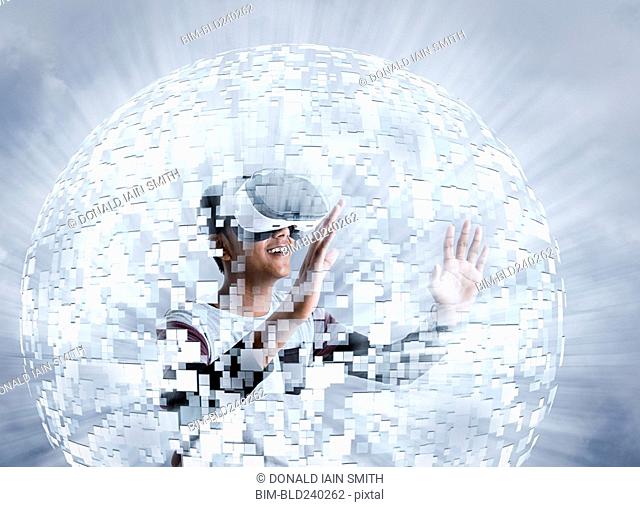 Fiji Indian boy wearing virtual reality goggles in floating sphere