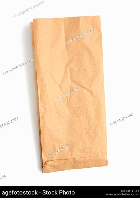 empty paper disposable bag of brown kraft paper isolated on white background, concept of rejection of plastic packaging, template for designer