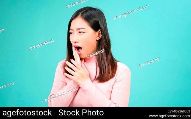 Portrait young Asian beautiful woman wear silicone orthodontic retainers on teeth feeling pain toothache holding her cheek with hand isolated on blue background