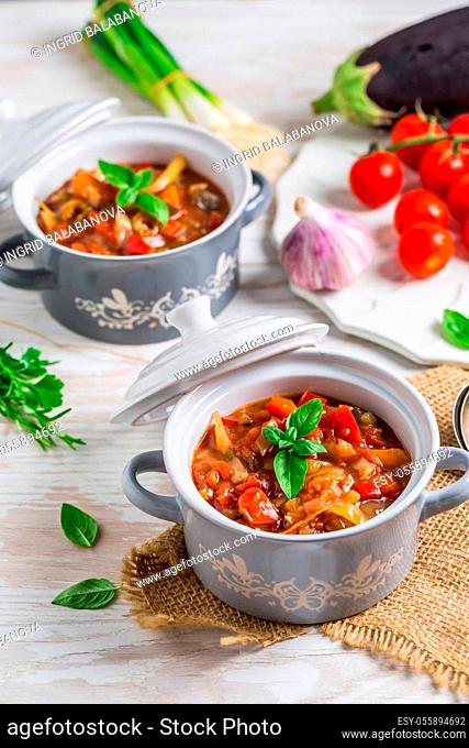 Delicious Italian vegetable minestrone soup served in small pots with ingredients