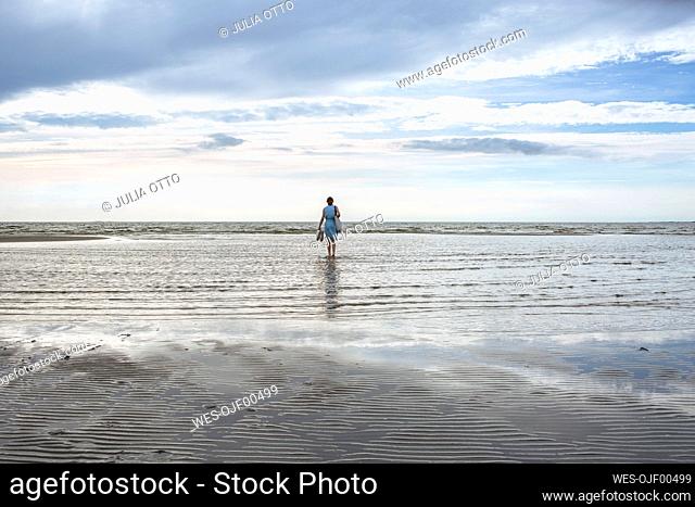 Girl standing in water at beach